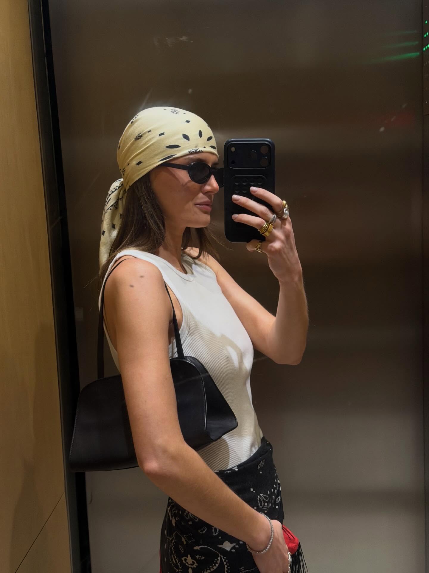 Woman wearing silk scarf in hair.