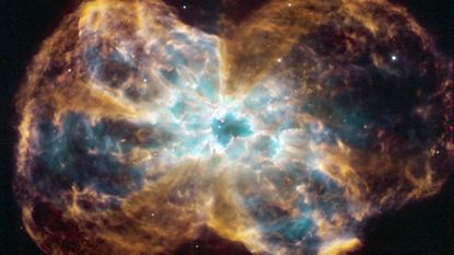 An image of a star shedding layers of gas at the end of its life and leaving a white dwarf behind. 