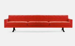 Long orange leather sofa with black legs