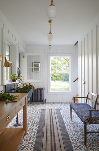 white entryway with patterned tile floor