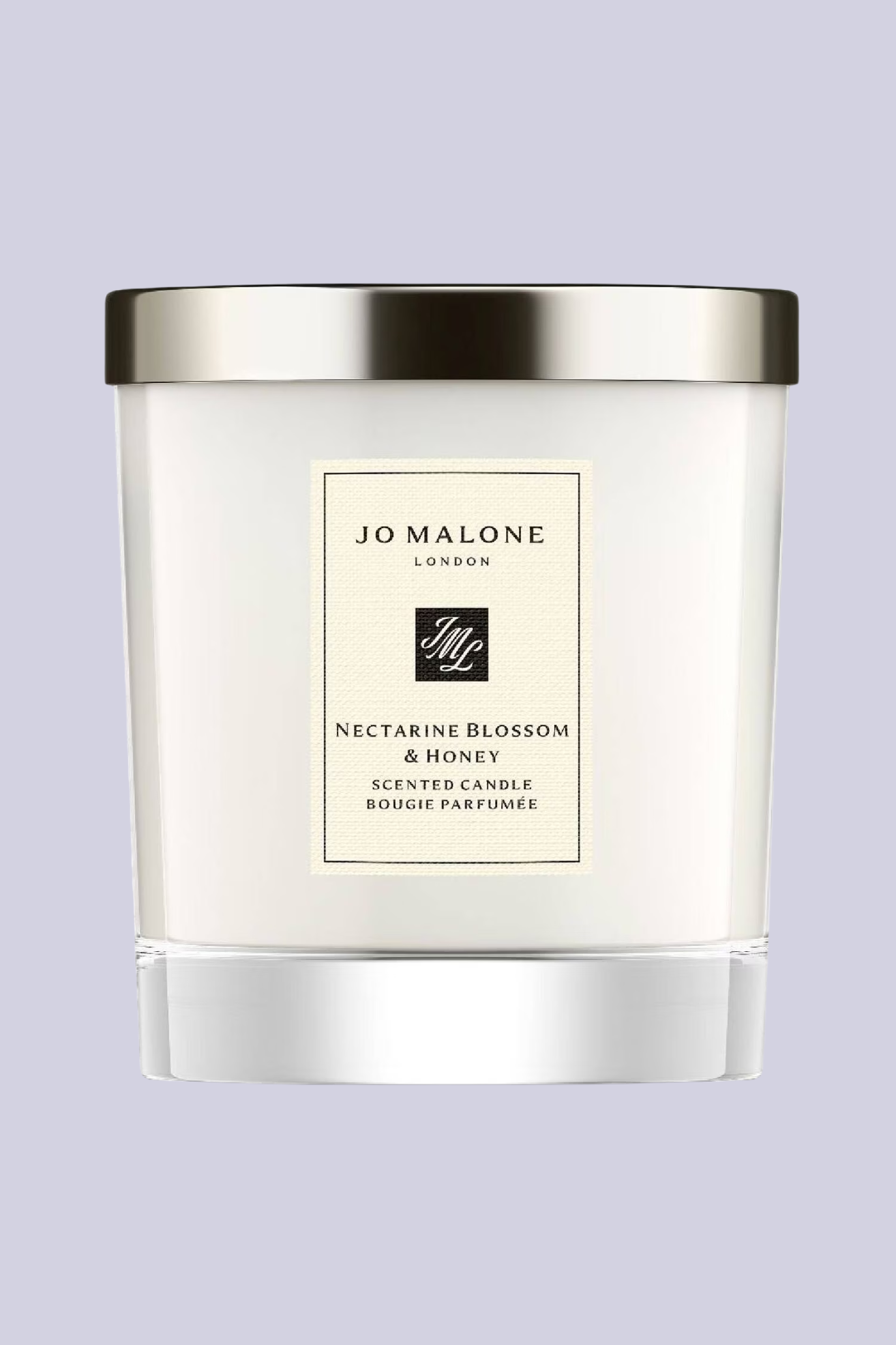 A white glass candle with a silver lid