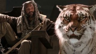 Khary Payton sitting behind a tiger in The Walking Dead