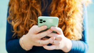 Woman texting on green phone