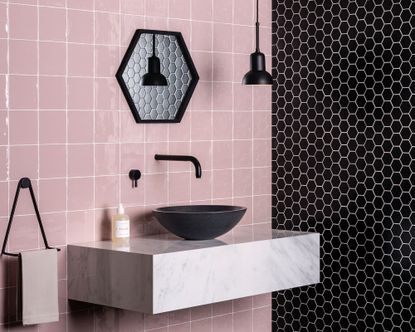 Black and pink tiled bathroom with black sink by Original Style