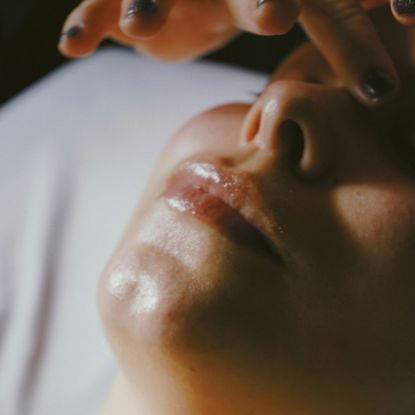 woman lying down getting a facial massage