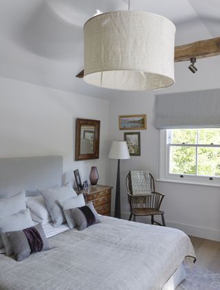 bedroom with neutral decor, pendant lampshade and Roman blind