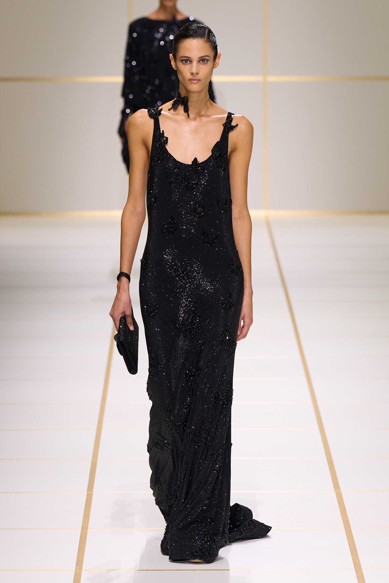 a model walks the giorgio armani s/s 27 runway.