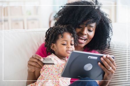 Mother and daughter shopping on tablet computer