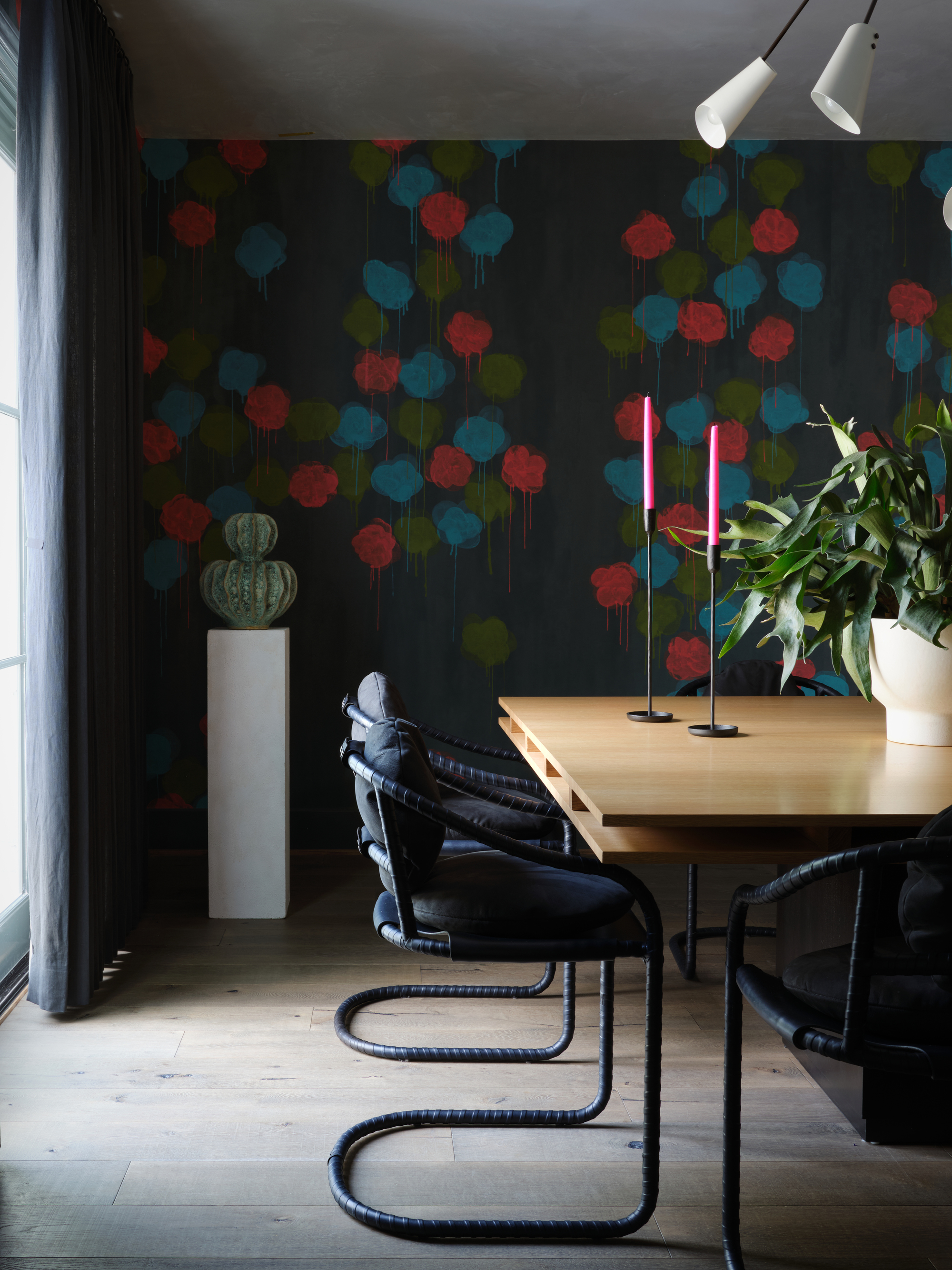 dining room with patterned wallpaper, chairs and a table