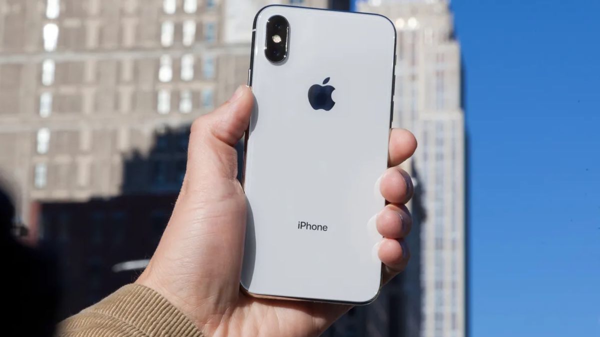 iPhone X in hand