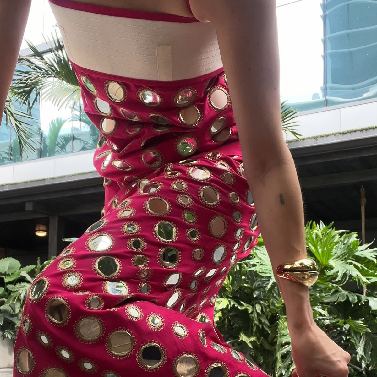 Eliza Huber wearing a pink mirrored Tory Burch dress.