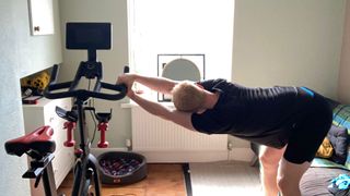 Fit&Well fitness writer Harry Bullmore performing the lat stretch