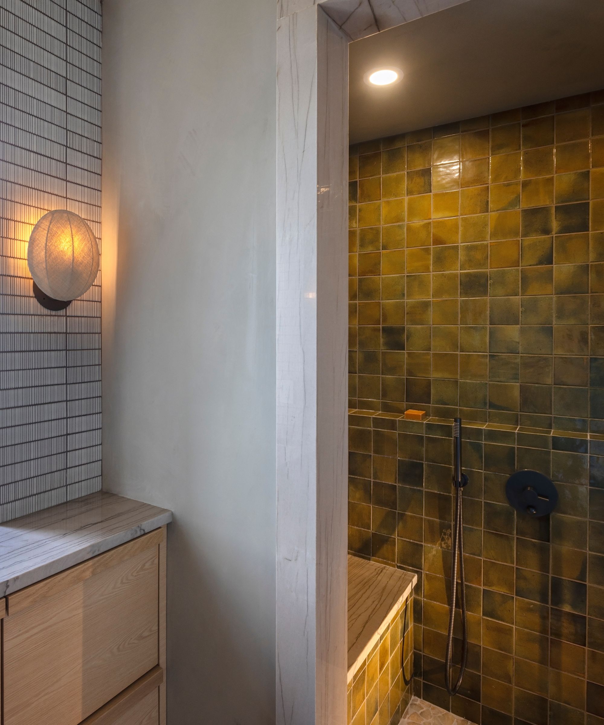 Walk in shower with mossy green square tiles