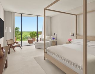 white bedroom with doors to terrace