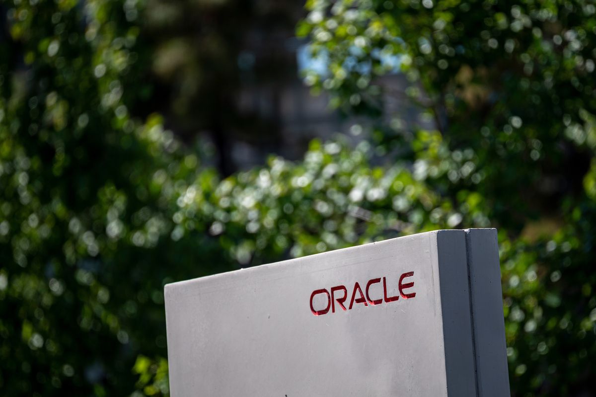 Oracle logo on a grey concrete block, a sign outside the driveway entrance to one of its office buildings