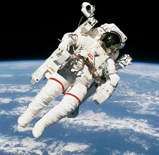 NASA astronaut Bruce McCandless making the first-ever tetherless spacewalk in the MMU "jetpack" in 1984.