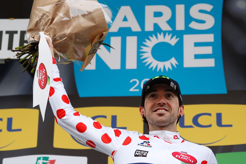 Jon Izagirre celebrates on the podium with his jersey for top climber