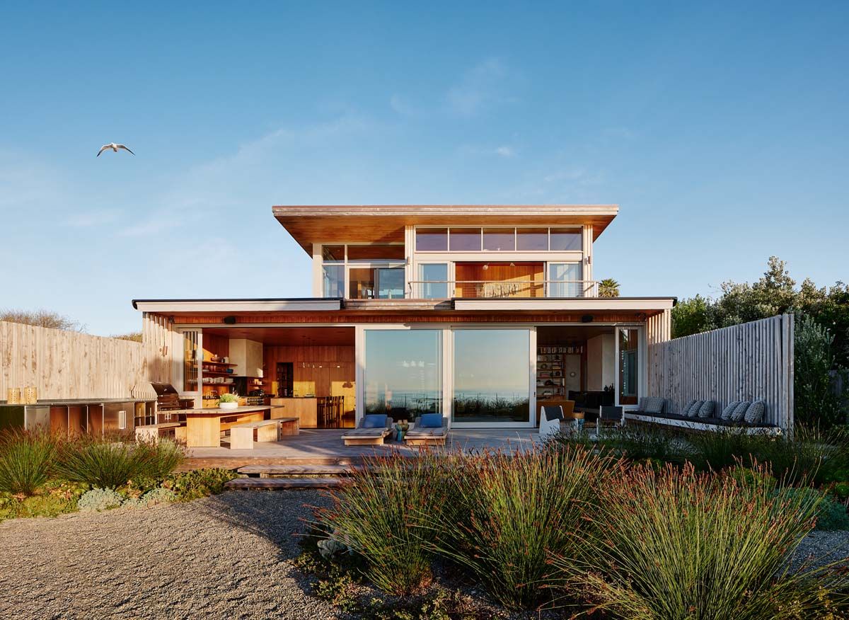 hero image of the Surf House among sand dunes and blue skies