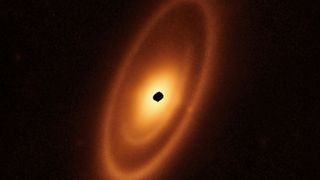 An infrared JWST image of the star Fomalhaut shows a large dark gap in its disk where an exoplanet has likely formed