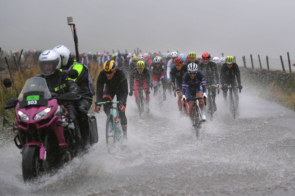 The Netherlands' Jos van Emden leads the peloton through one of the course's larger puddles