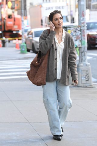 Katie Holmes walking to the theatre for rehearsals in a gray cardigan and jeans