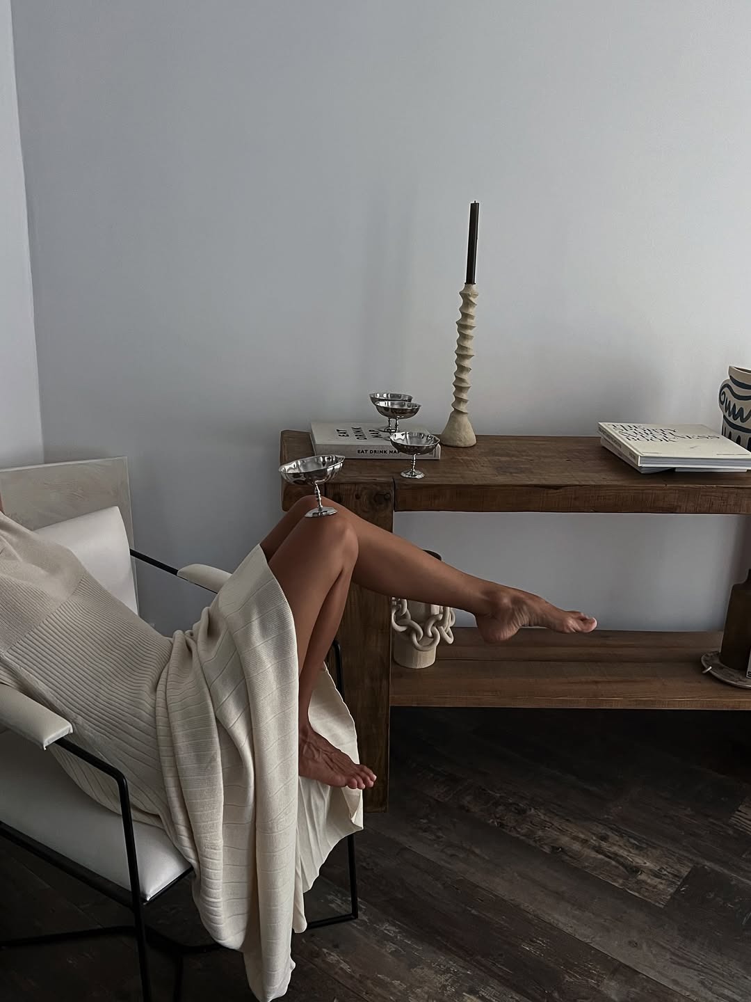 An image of someone balancing a martini glass on their knee.