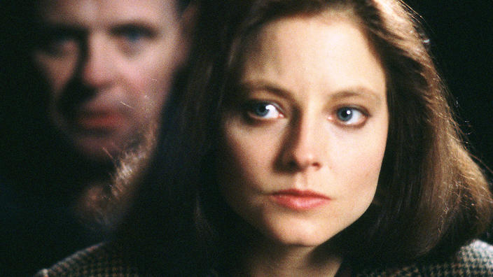 Jodie Foster as Clarice Starling in SIlence of the Lambs, with Anthony Hopkins&#039; Hannibal Lecter reflected back at her