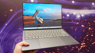 A person holding Lenovo's Project AeroBlade concept laptop in hand