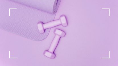 purple dumbbells and yoga mat on purple background 