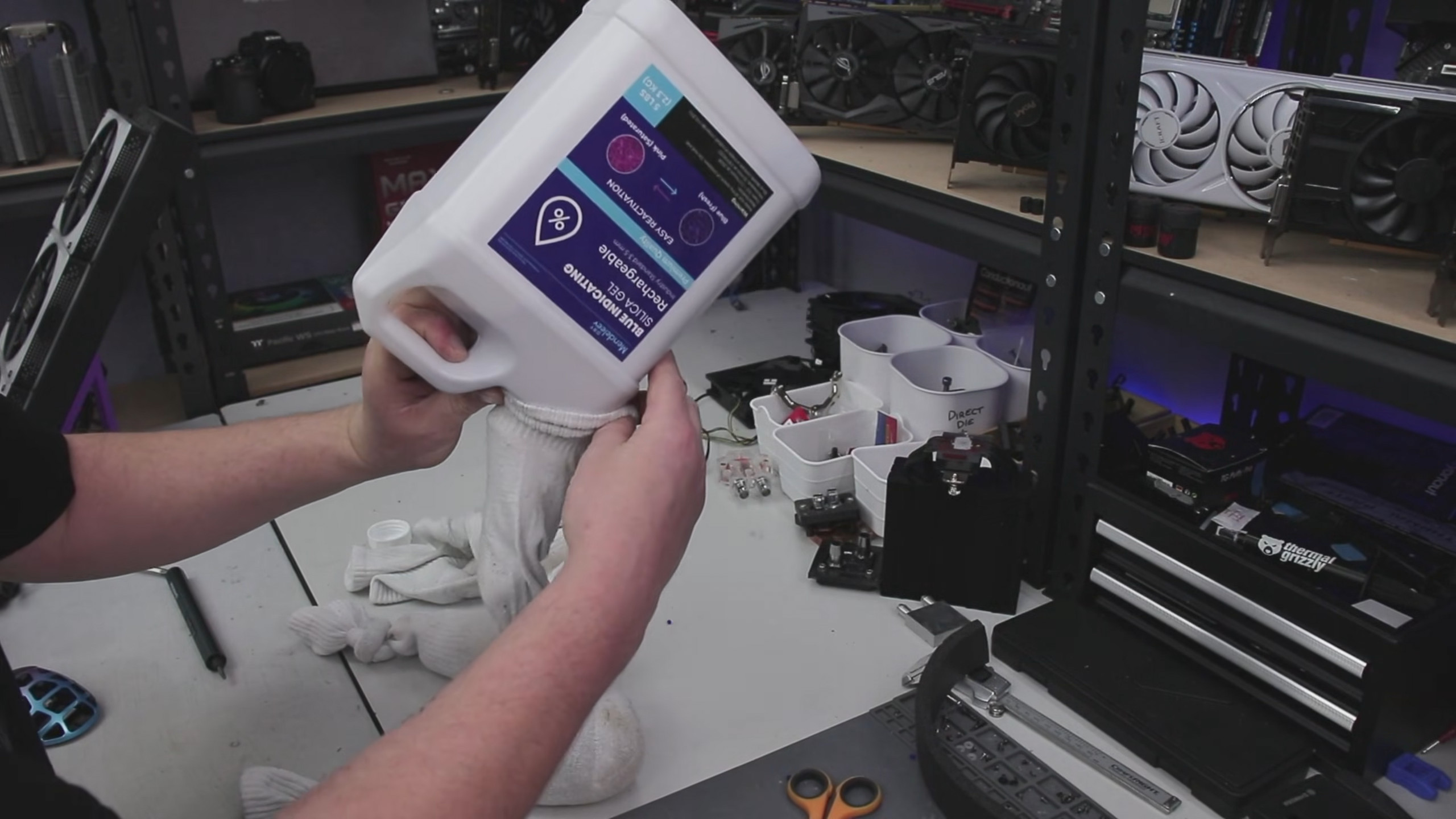 A photo of a man pouring silica gel desiccant into socks.