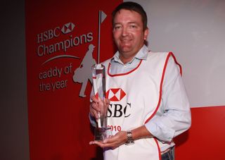 Ken Comboy poses with the 2010 Caddie of the Year award