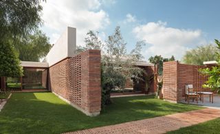House exterior with brick walls and grassland