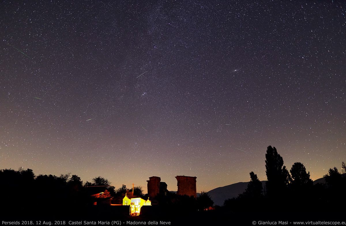 Several Perseid meteors dash across the sky above Italy&#039;s Castel Santa Maria in this photo by astrophysicist Gianluca Masi of the Virtual Telescope Project taken during the peak on Aug. 12-13, 2018.