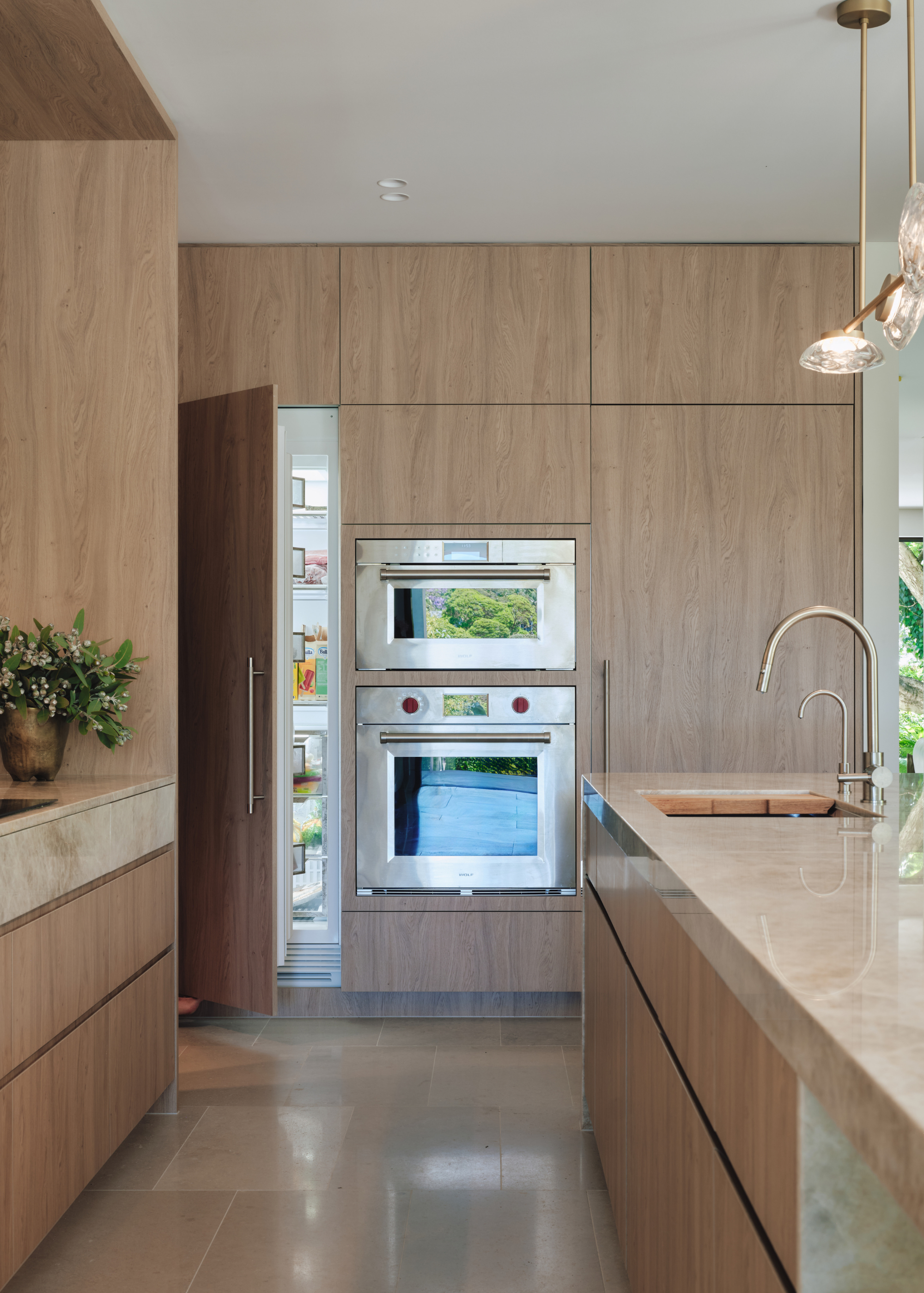 A minimalist kitchen with an open fridge