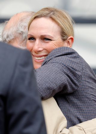 Zara Tindall and King Charles embrace