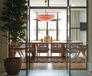 dining area with floor to ceiling windows and chandelier