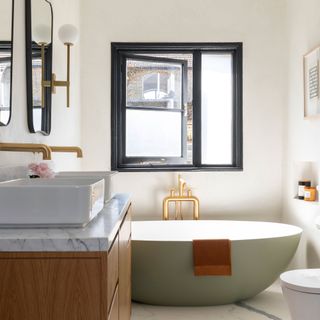modern bathroom with green tub, gold shower and double sink