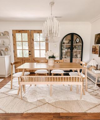 Neutral dining room with wooden table and neutral rugs