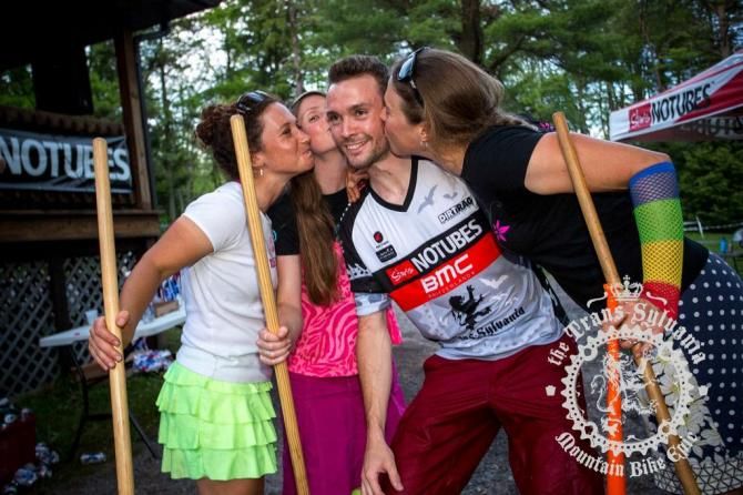 Stage 8 champion is kissed by Sarah Kaufmann, Vicky Barclay and Amanda Carey. Note the rainbow armwarmers on Carey, who was serving as head official during stage 8