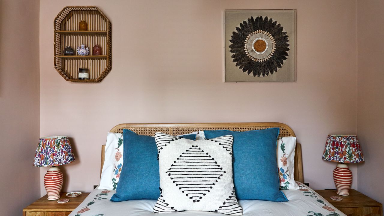 Pink bedroom with patterned cushions on the bed