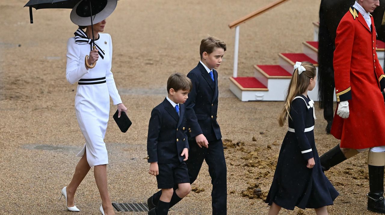 Catherine, Princess of Wales, shelters from the rain with an umbrella as she walks with her children Britain&#039;s Prince George of Wales (C), Britain&#039;s Princess Charlotte of Wales (R) and Britain&#039;s Prince Louis of Wales back to the Glass State Coach at Horse Guards Parade during the King&#039;s Birthday Parade &quot;Trooping the Colour&quot; in London on June 15, 2024.