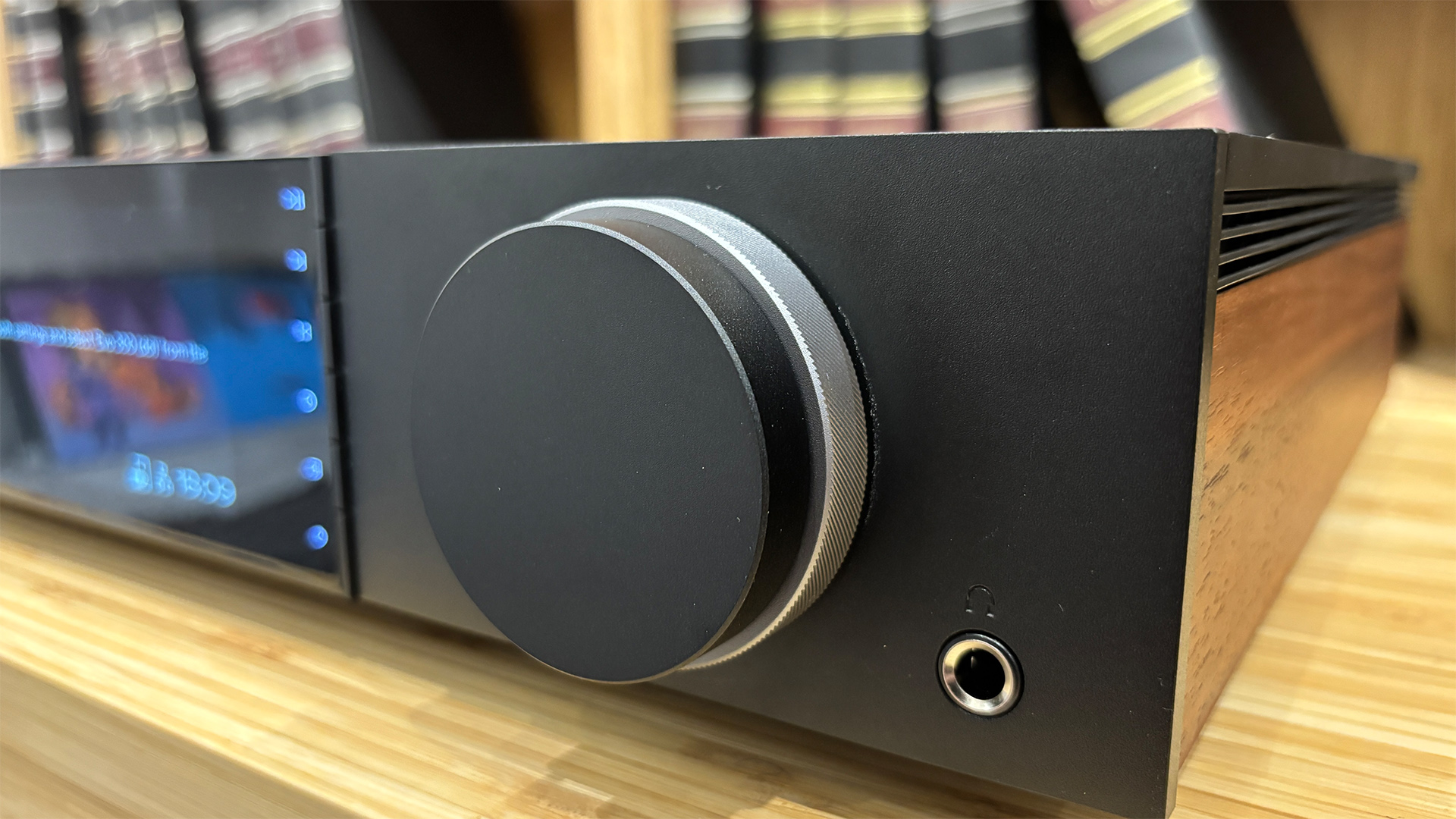 Cambridge Audio Evo 300 all-in-one system on wooden hi-fi rack close up on volume dial