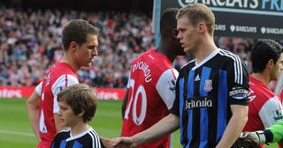 Aaron Ramsey of Arsenal shakes hands with Stoke defender Ryan Shawcross before the Barclays Premier League match between Arsenal and Stoke City at Emirates Stadium on October 22, 2011 in London, England.