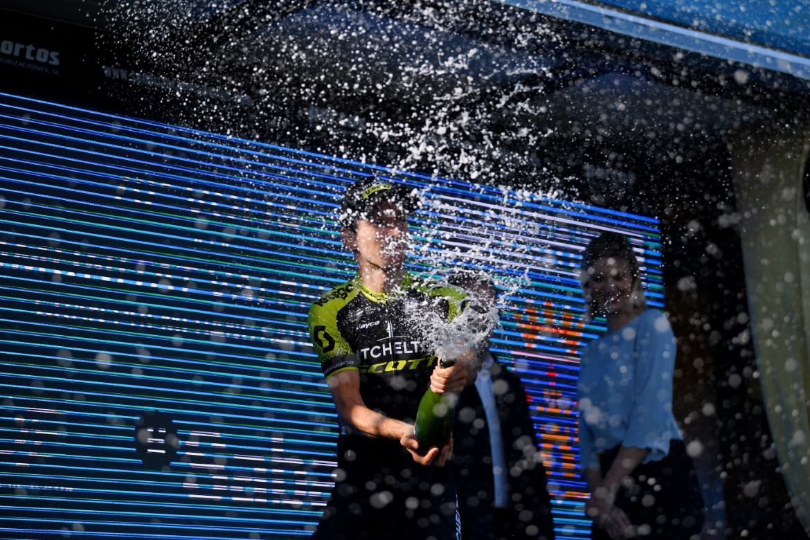 Adam Yates sprays the champagne