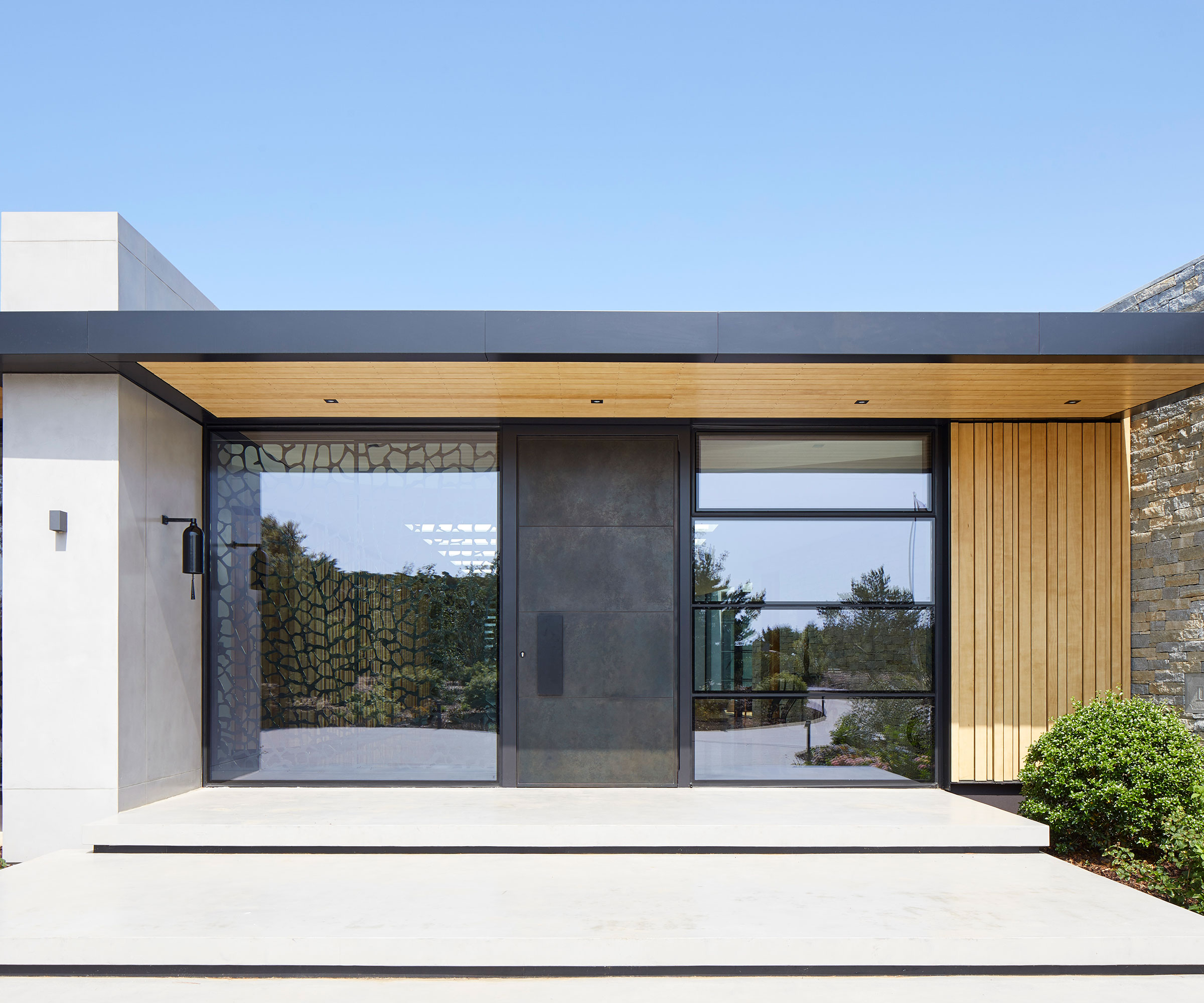 modern flat roof porch with timber clad underside