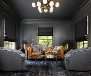 Art Deco living room painted black with gold statement lighting