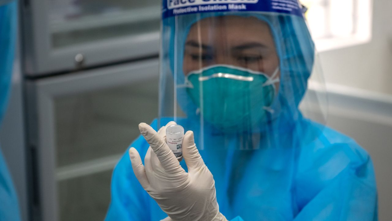 A Vietnamese health worker draws up a Covid vaccine dose