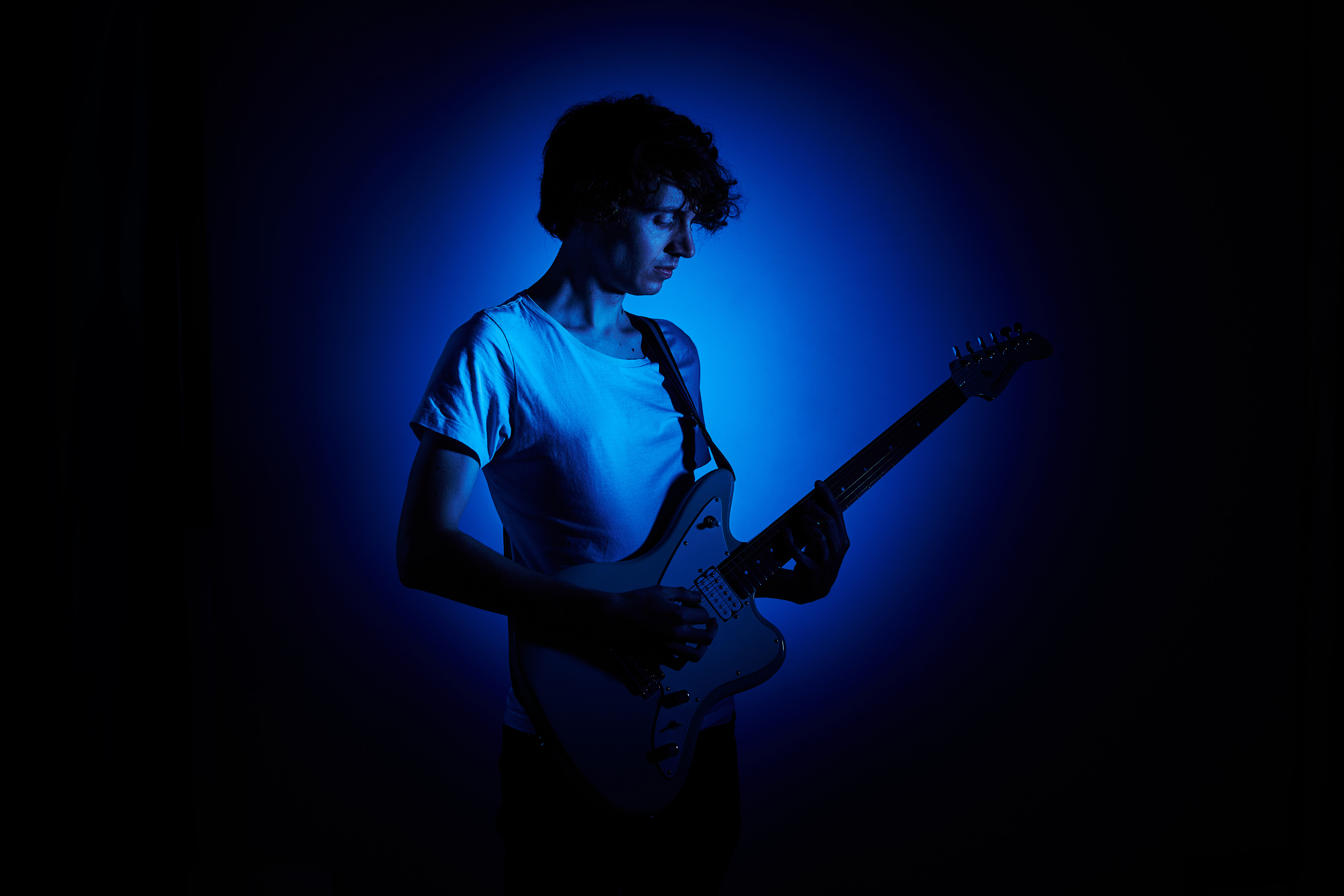 Studio shot of Maebe aka Michael Astley-Brown playing a Fernandes JG-40 offset electric guitar
