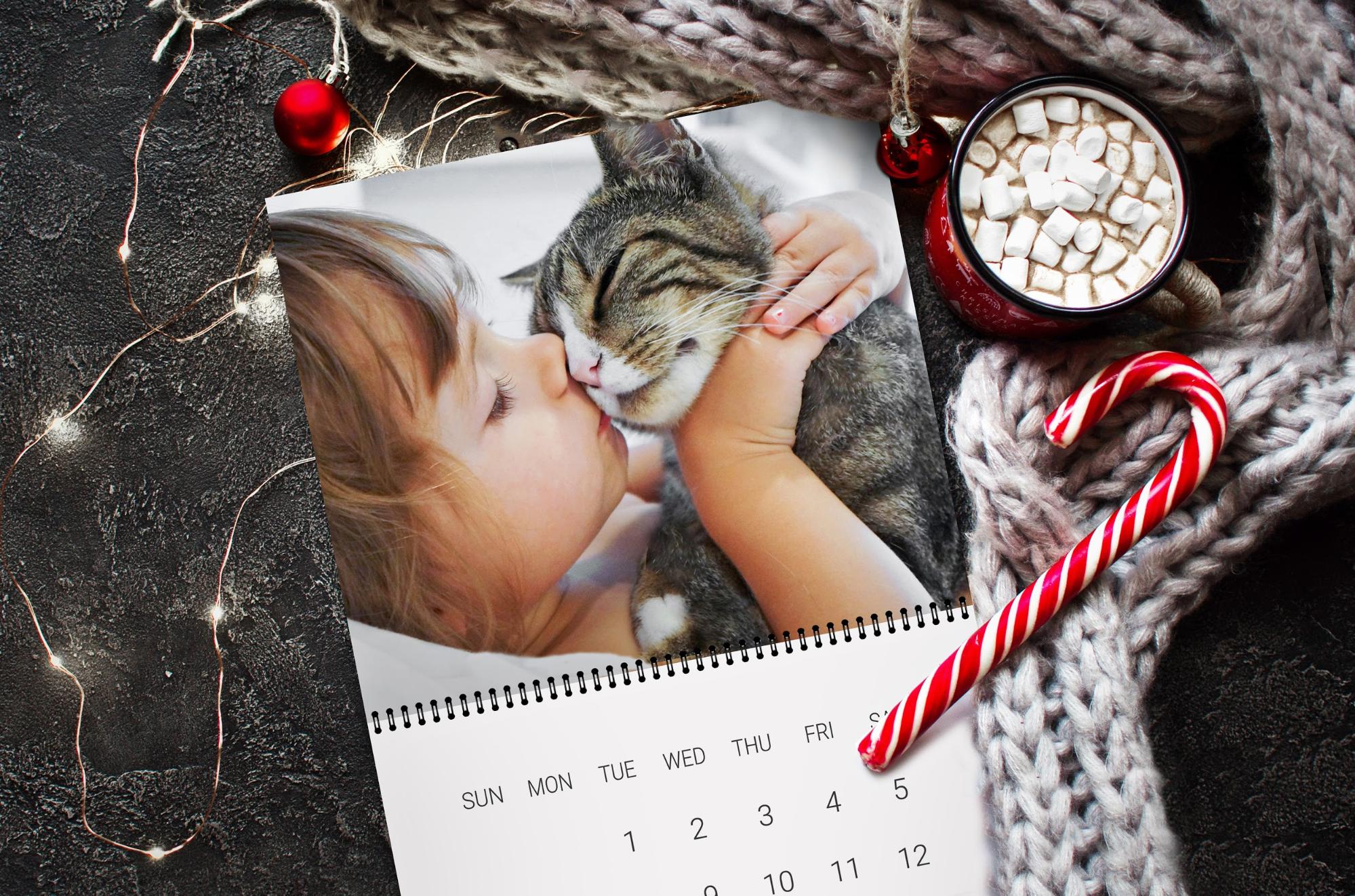 Calendar featuring photo of small girl kissing cat