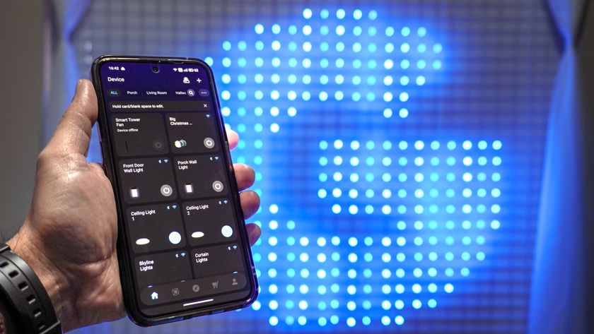 A person holding a phone with the Govee app open in front of the Govee Curtain Lights Pro showing the Govee logo